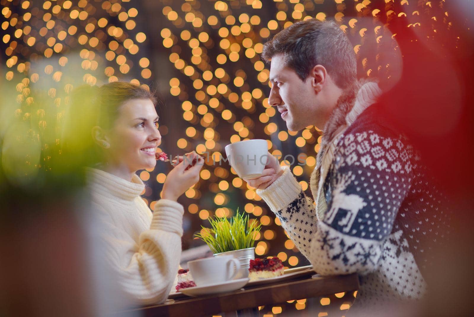 romantic evening date in restaurant  happy young couple with wine glass tea and cake