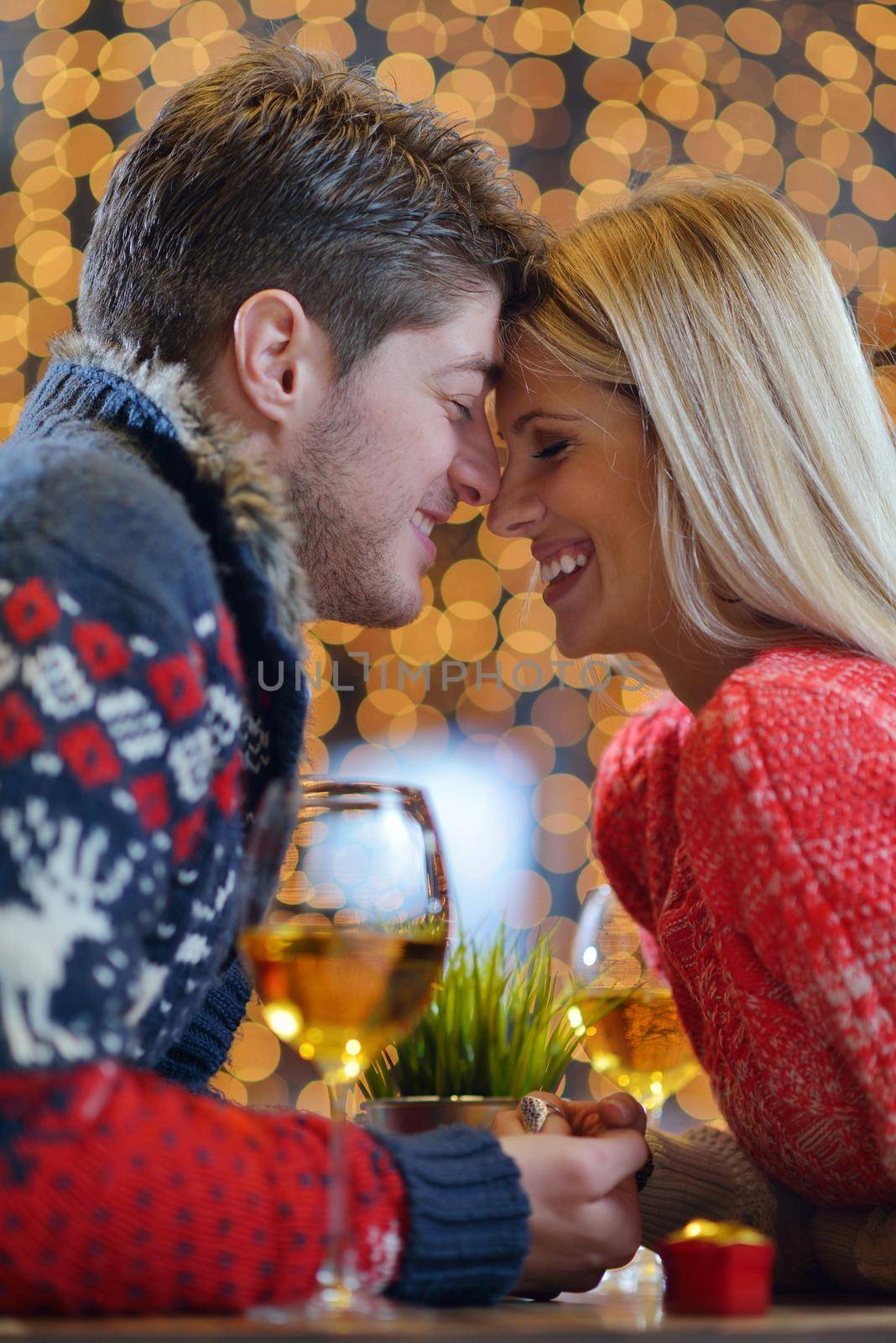 romantic evening date in restaurant  happy young couple with wine glass tea and cake