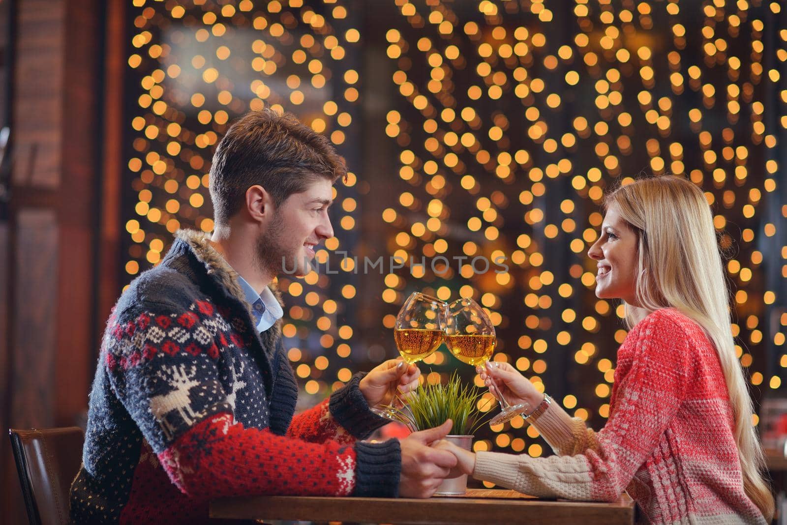 romantic evening date in restaurant  happy young couple with wine glass tea and cake