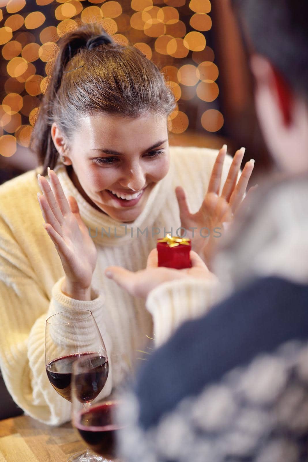 The young man gives a wedding ring   gift to  girl in restaurant