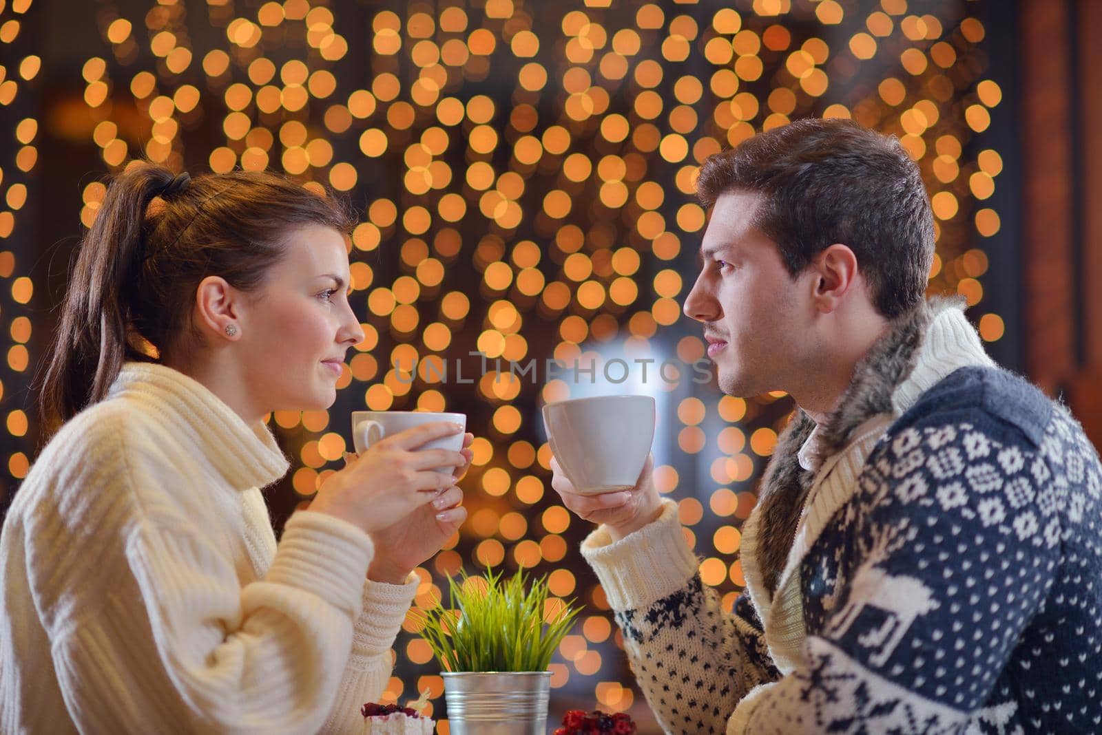 romantic evening date in restaurant  happy young couple with wine glass tea and cake