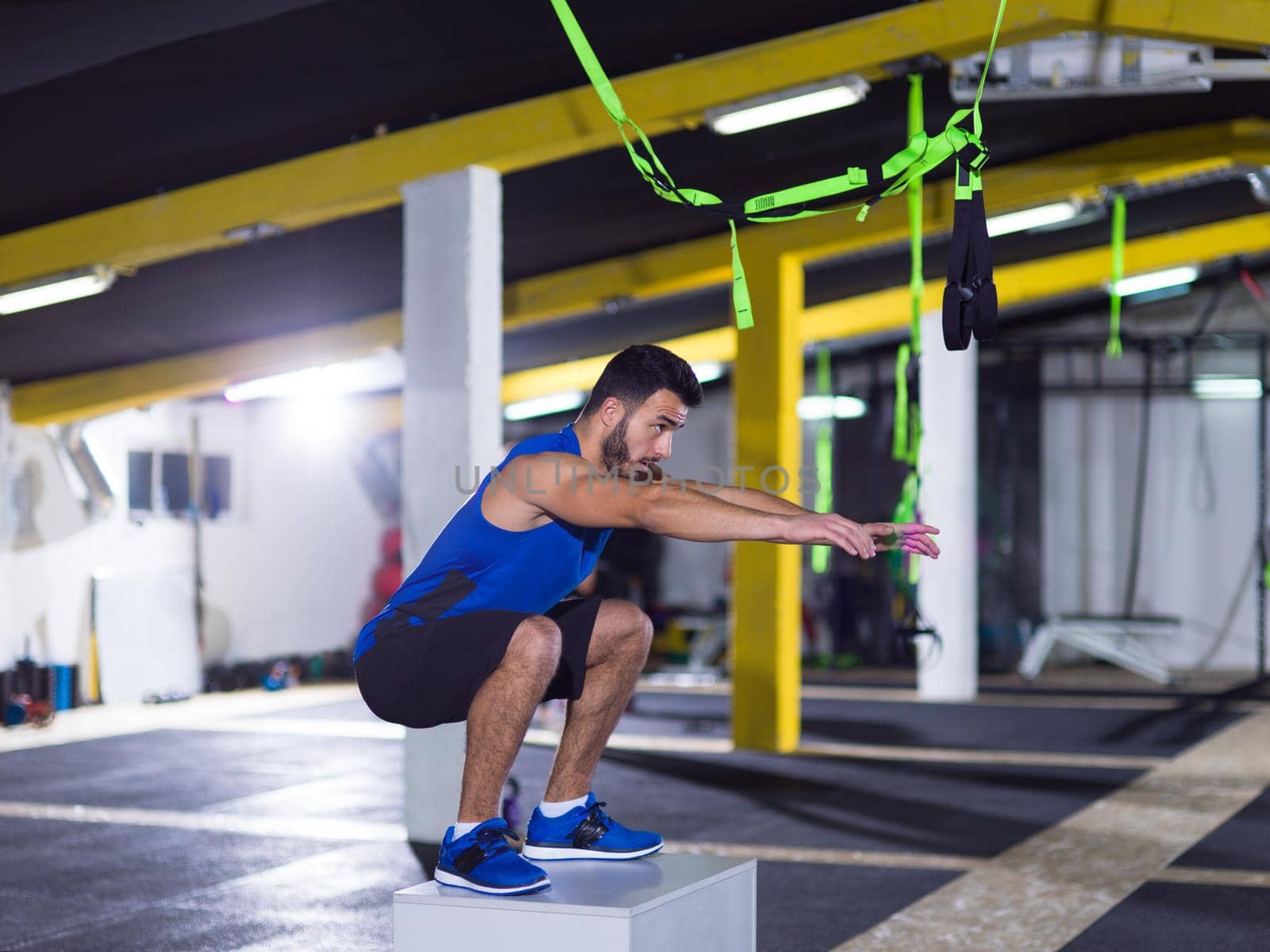 man working out jumping on fit box by dotshock