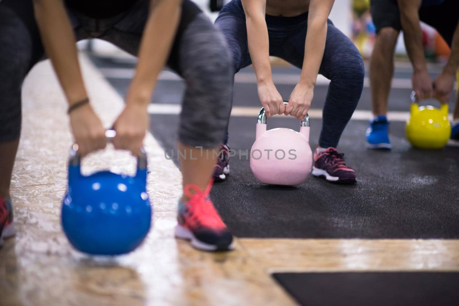 athletes doing exercises with kettlebells by dotshock