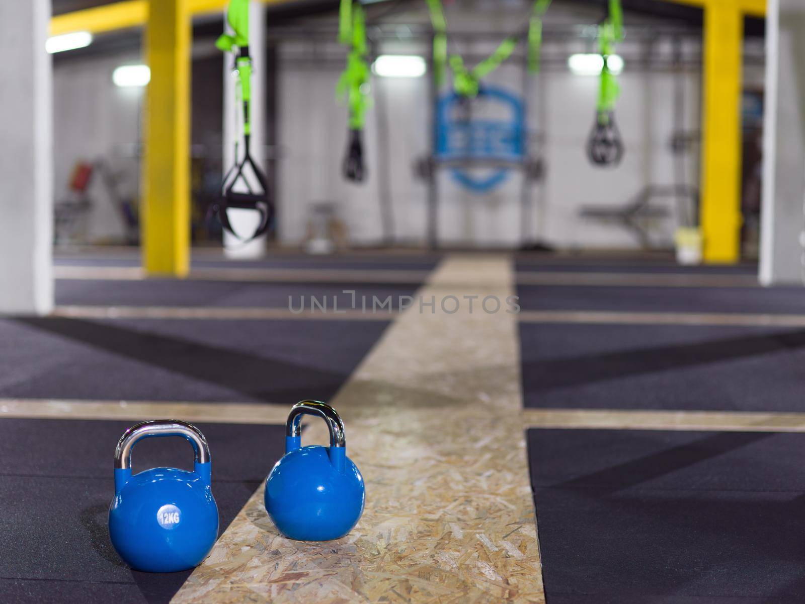 blue Crossfitness Kettlebells at fitness gym floor