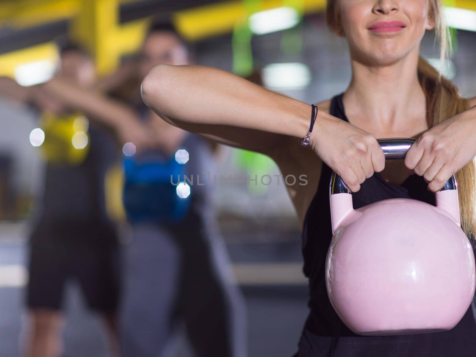 athletes doing exercises with kettlebells by dotshock