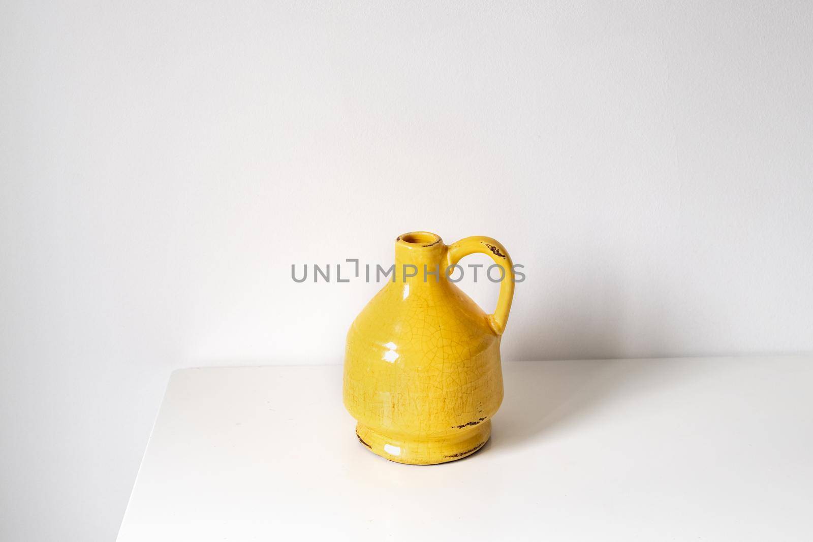 Yellow vase on a white background