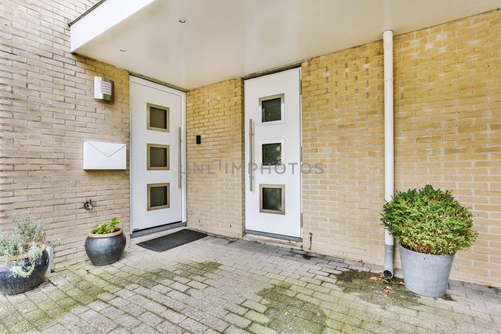 Residential building front door with white door