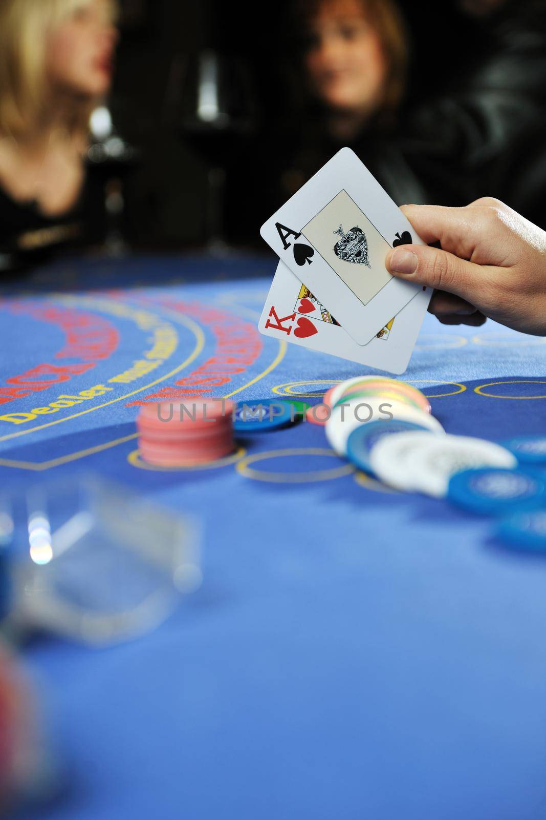 woman play black jack card game in casino by dotshock