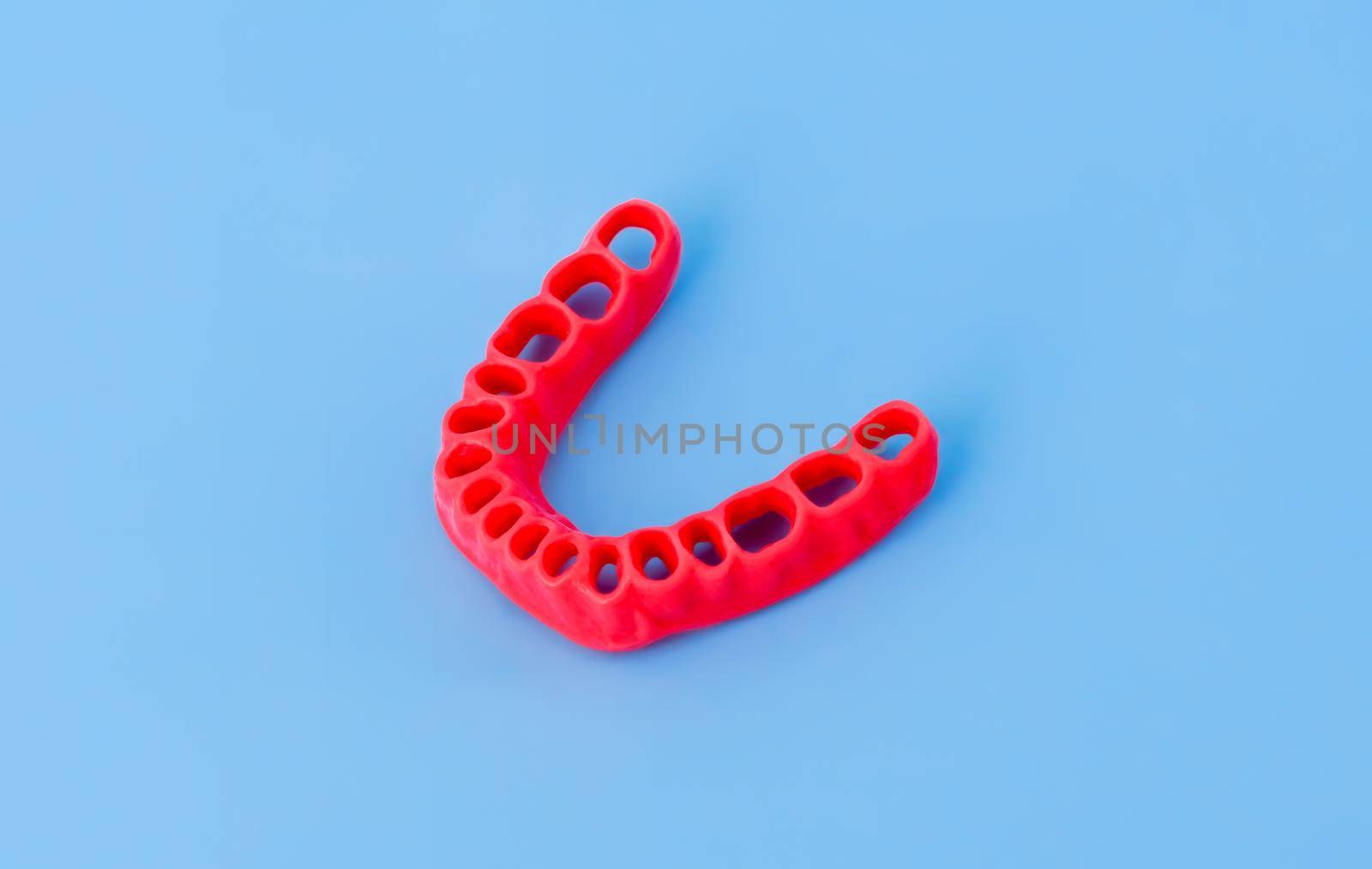 model of human gums without teeth isolated on blue by dotshock