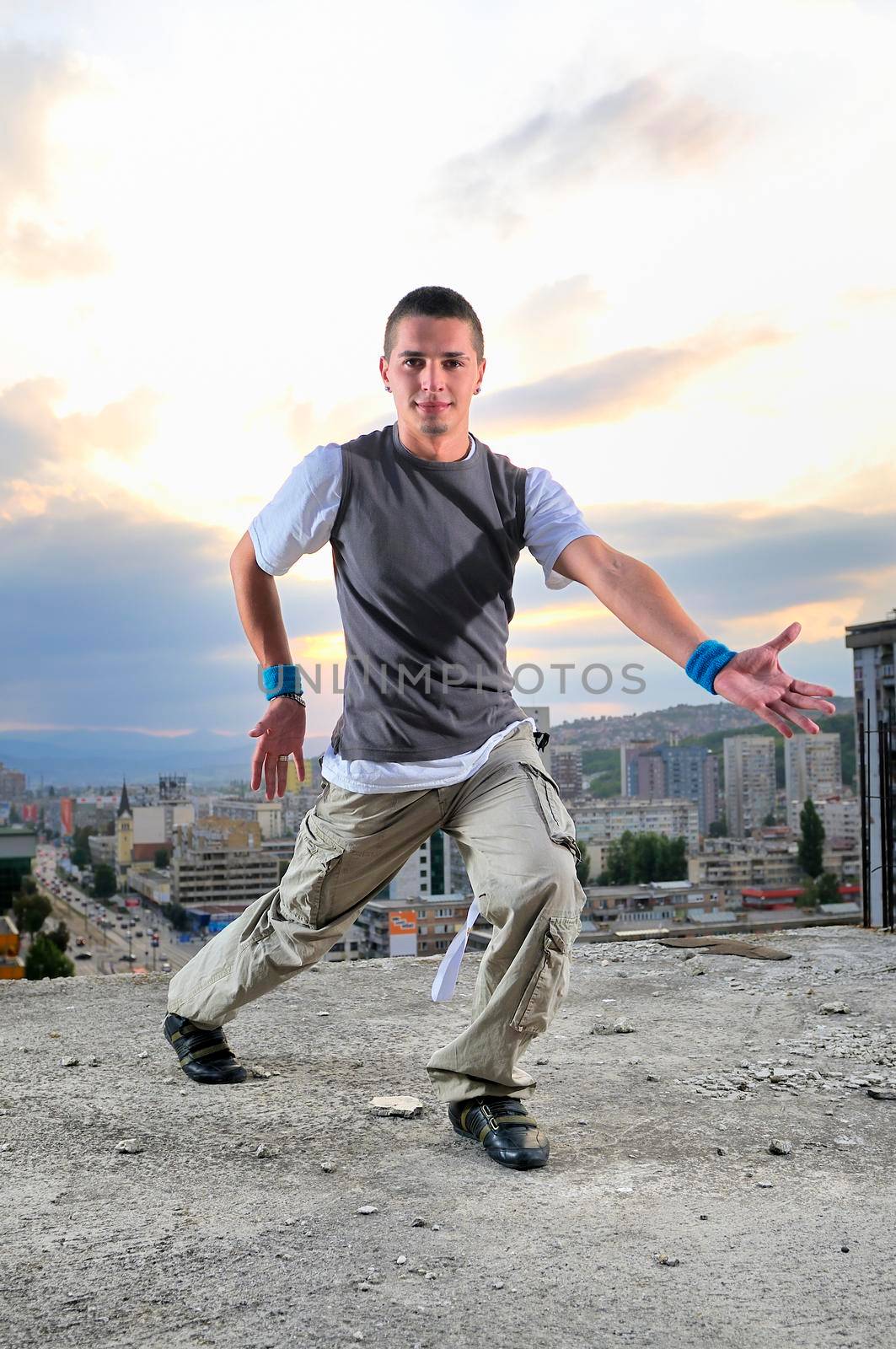 young man jumping in air outdoor at night ready to party by dotshock