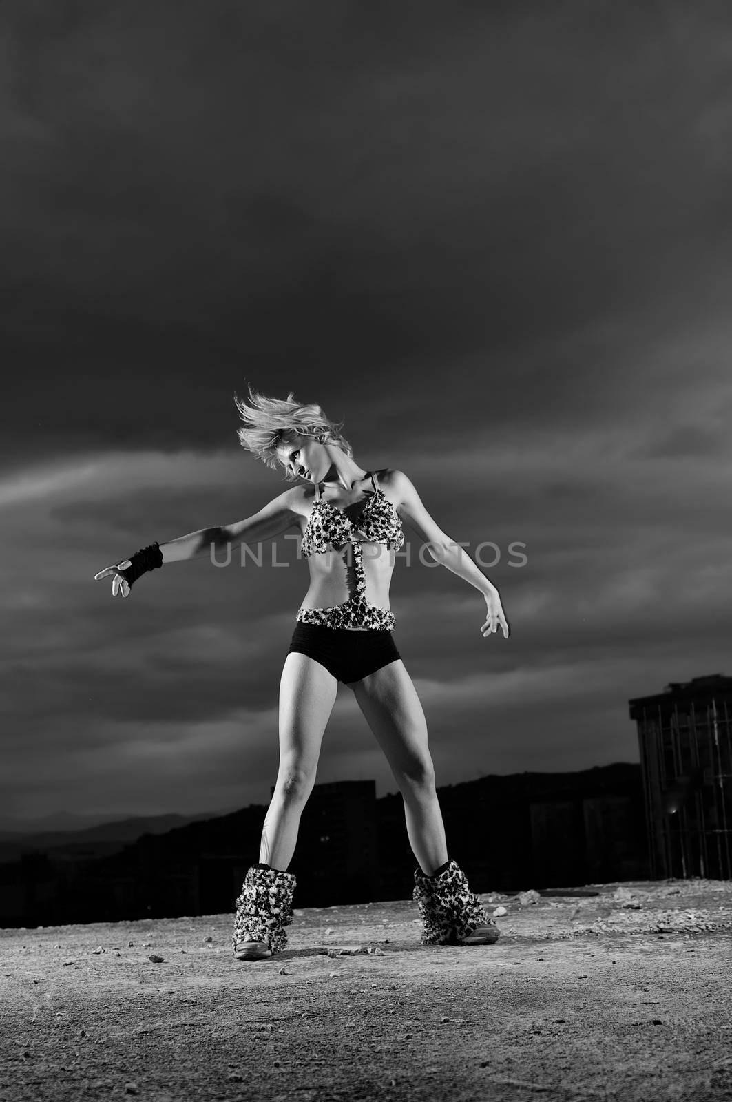 young gogo dancer girl on top of the building with city in backgound