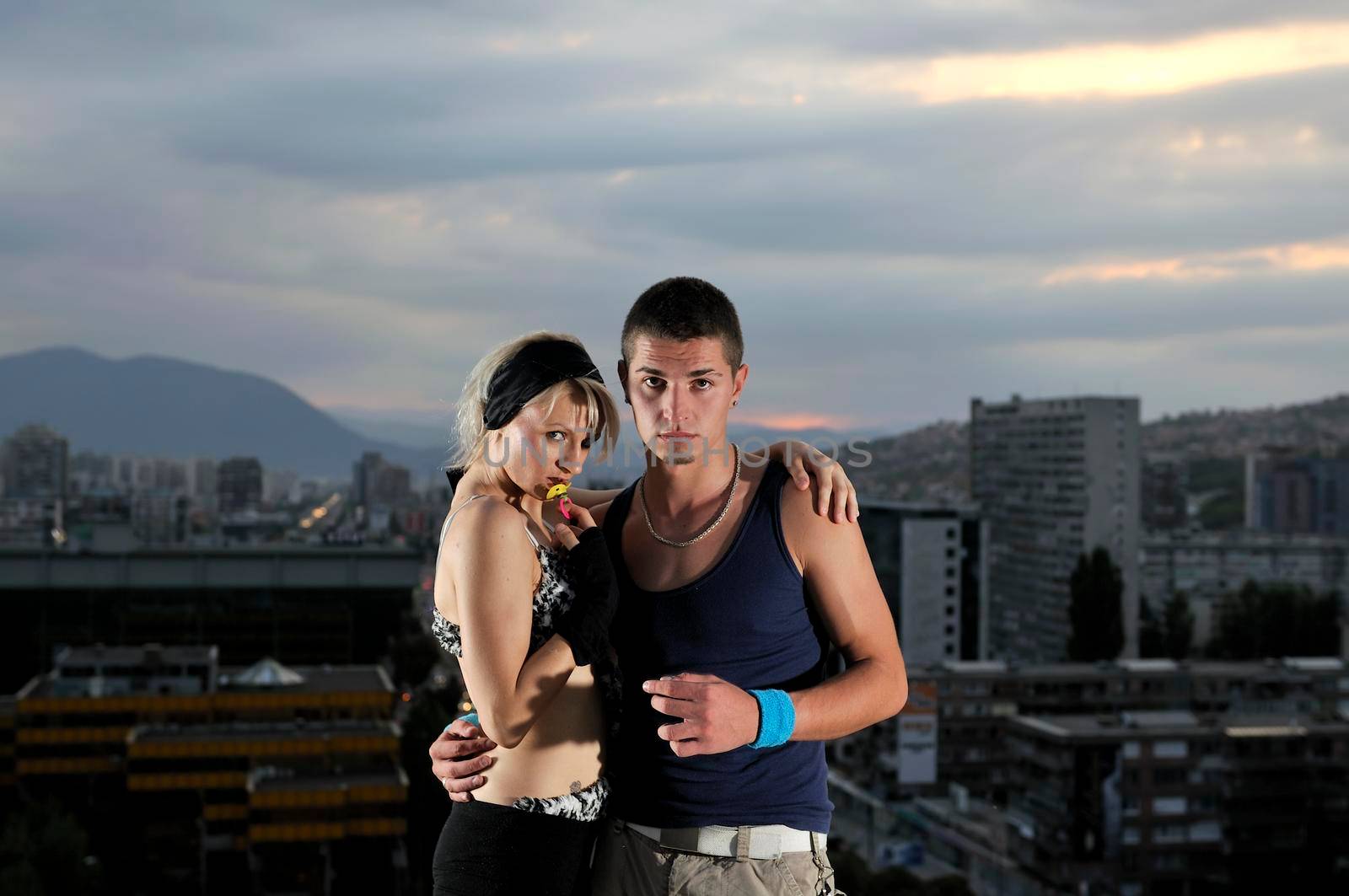 romantic urban couple dancing on top of the bulding  by dotshock