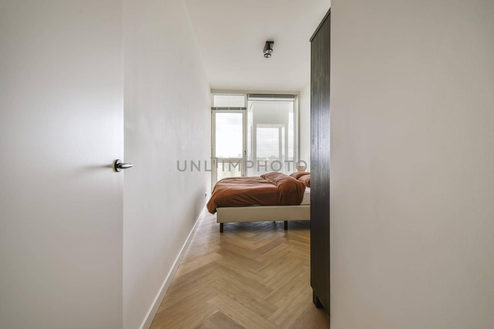 Luxurious bedroom with a brown fluffy bedspread on the bed