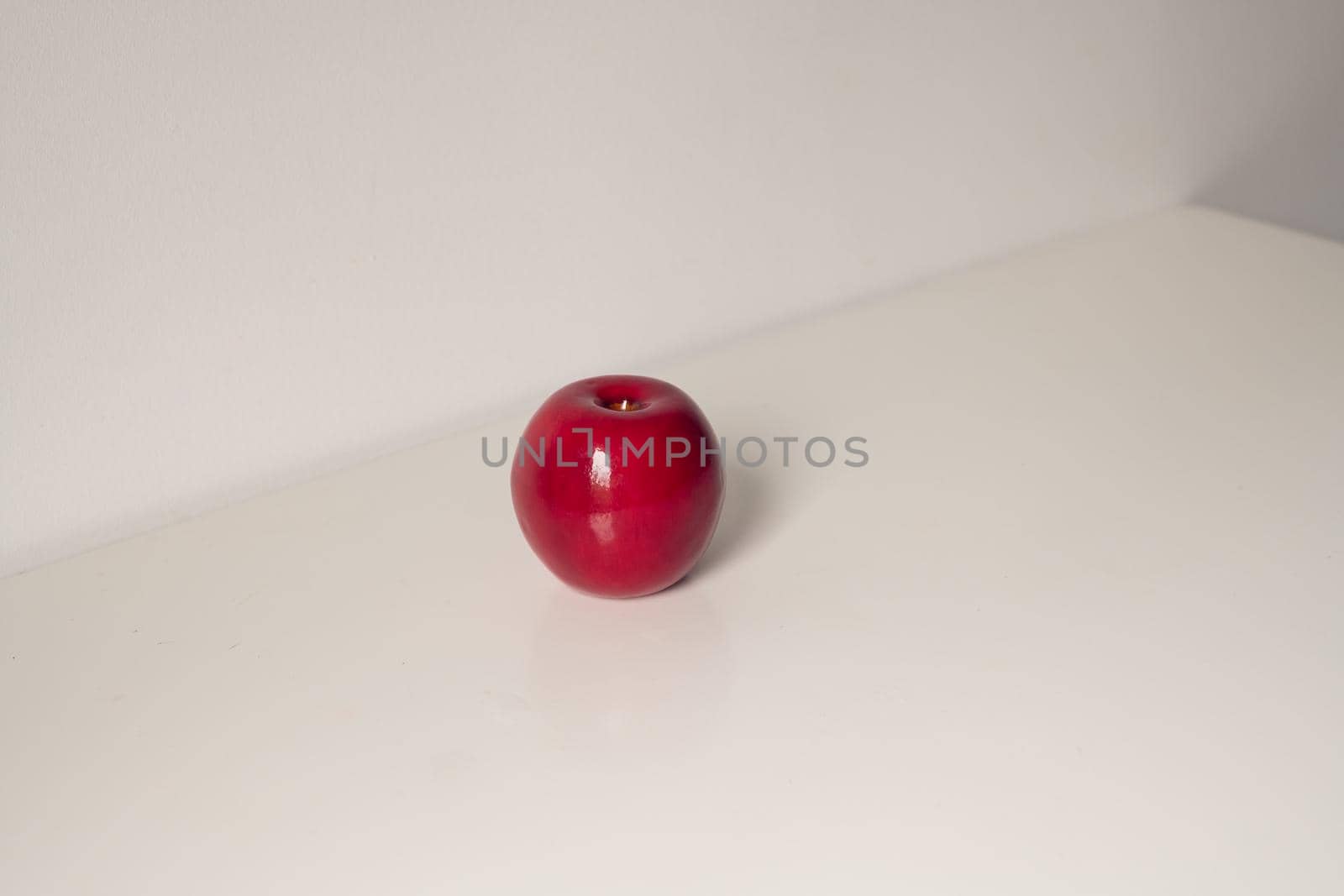 Red artificial apple on a white background