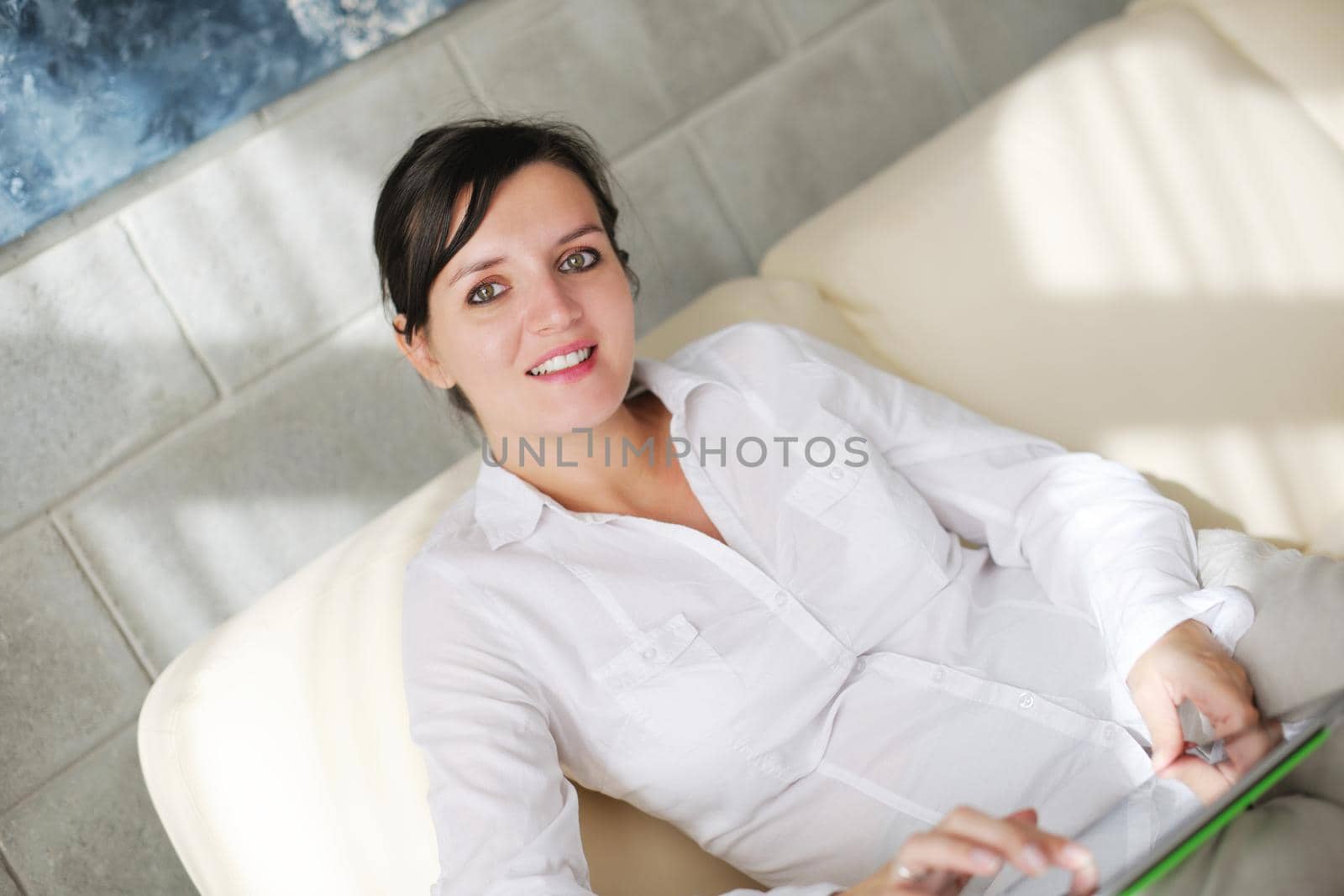 woman using tablet pc at home by dotshock
