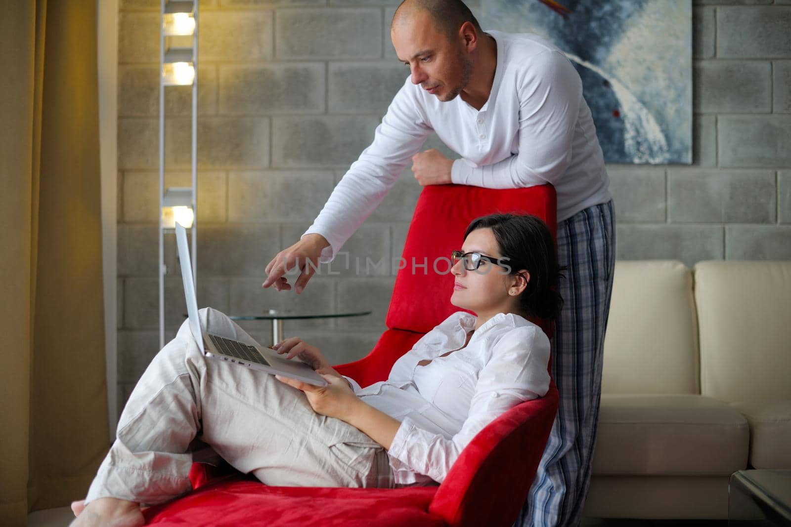 young couple using Laptop computer at home by dotshock