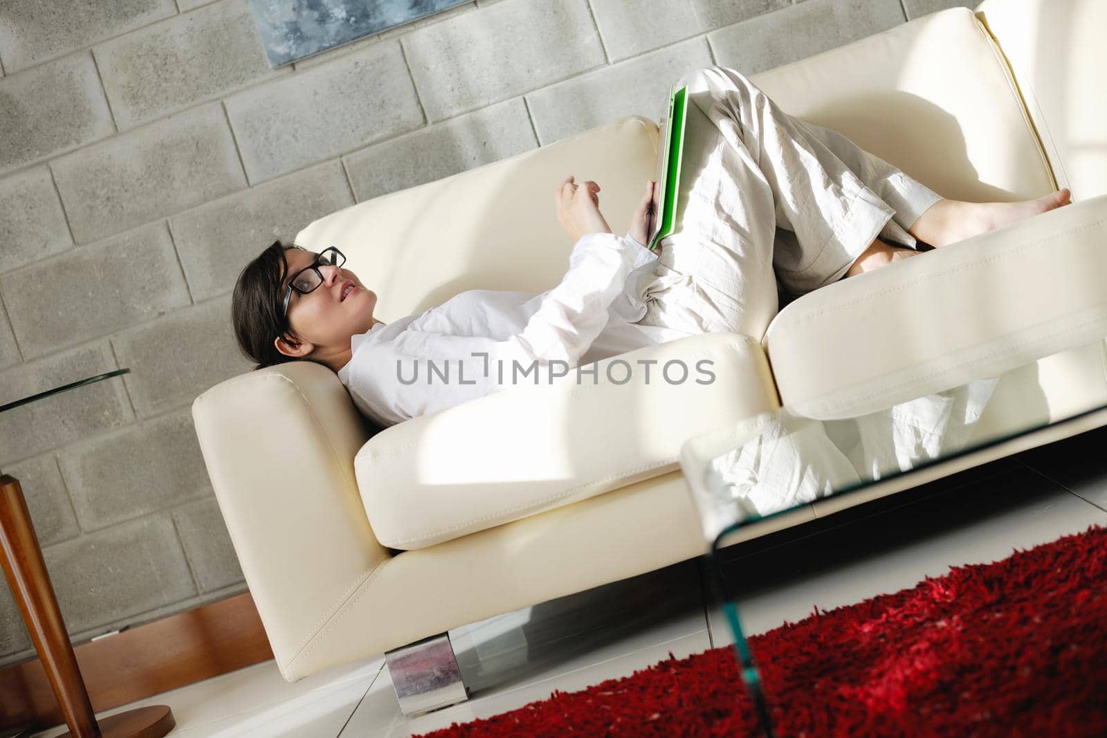 woman using tablet pc at home by dotshock