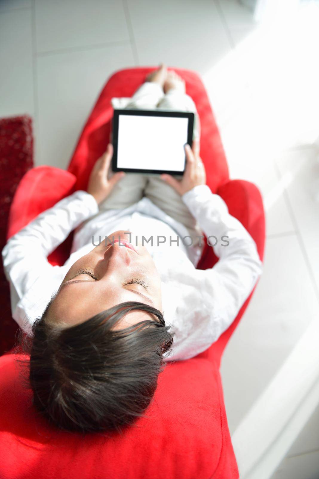 happy young woman watching tv at modern home livingroom