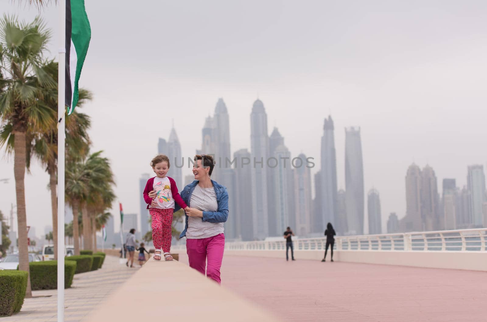 mother and cute little girl on the promenade by dotshock