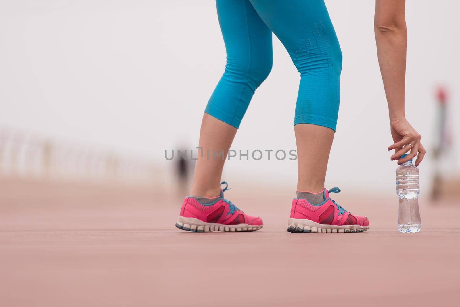 close up on running shoes and bottle of water by dotshock