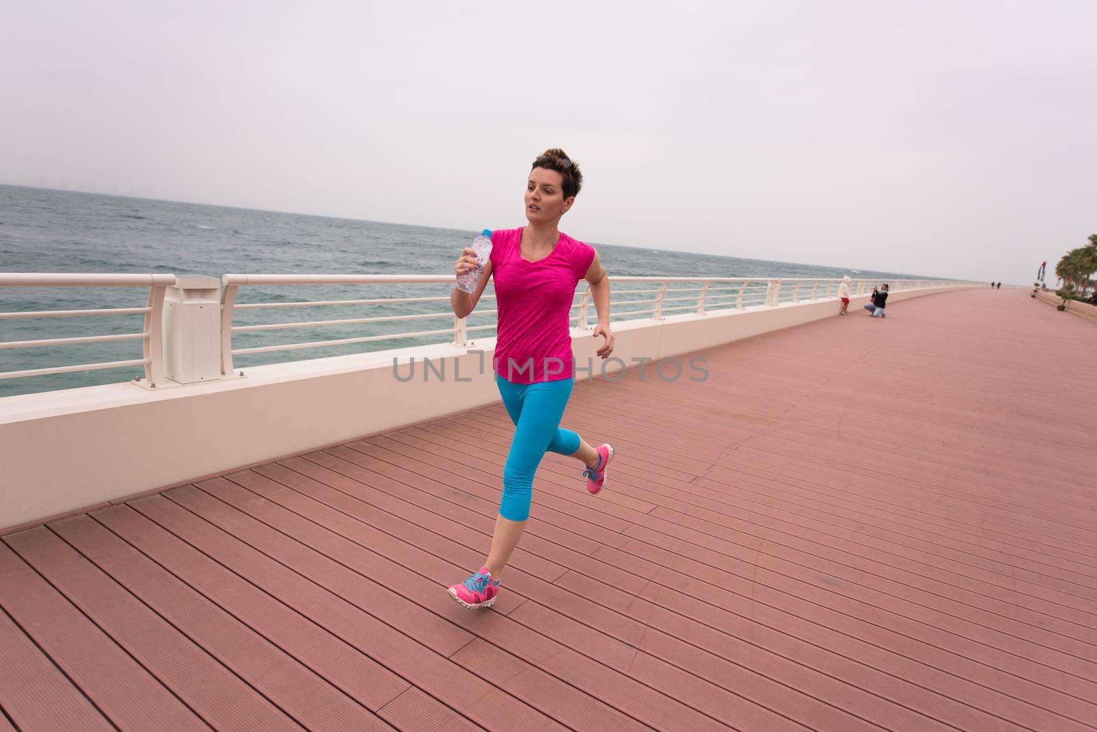 woman busy running on the promenade by dotshock