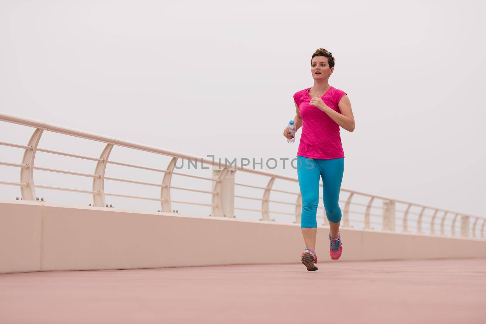woman busy running on the promenade by dotshock