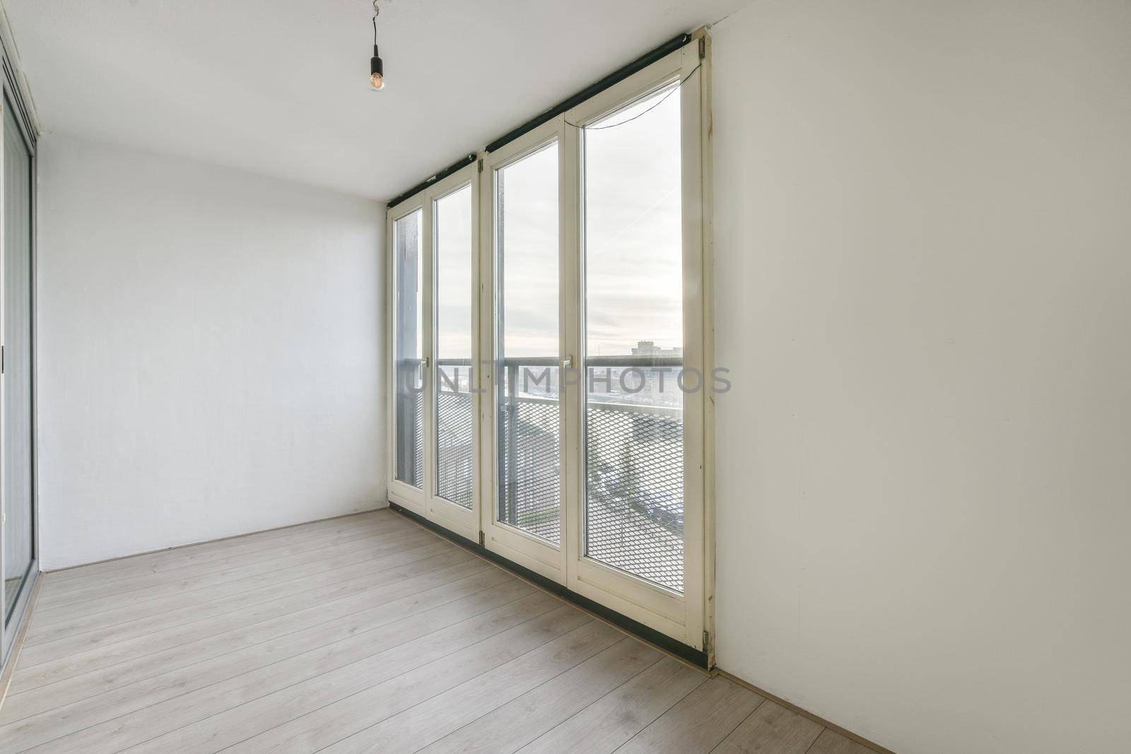 A bright room with large windows on the entire wall
