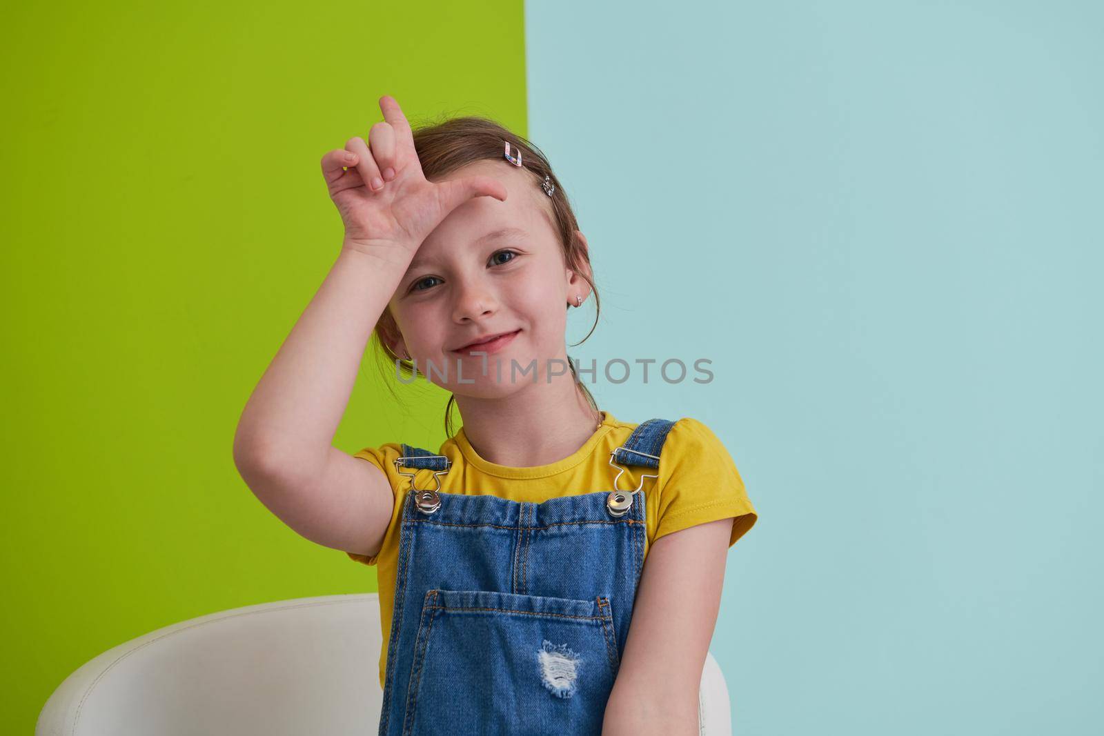 cute children portrait. Little girl smiling at home making funny face and acting