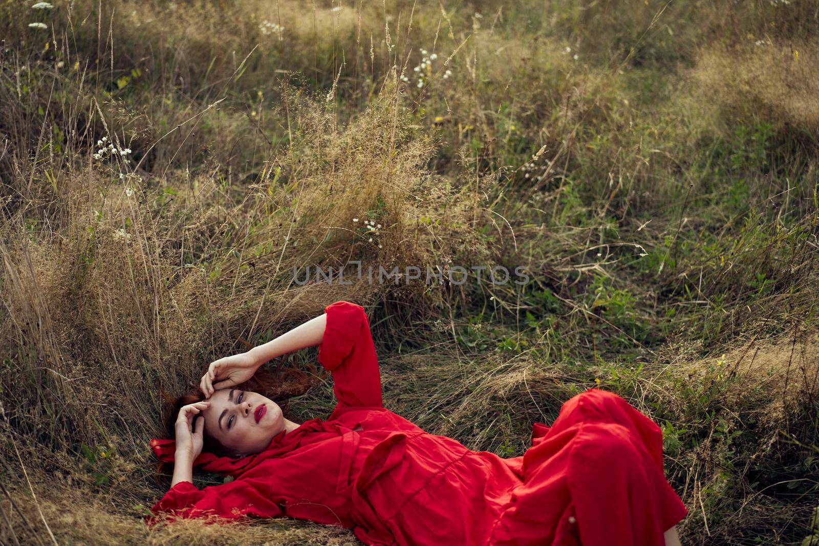 woman in a black dress lies in a field nature fashion summer by Vichizh