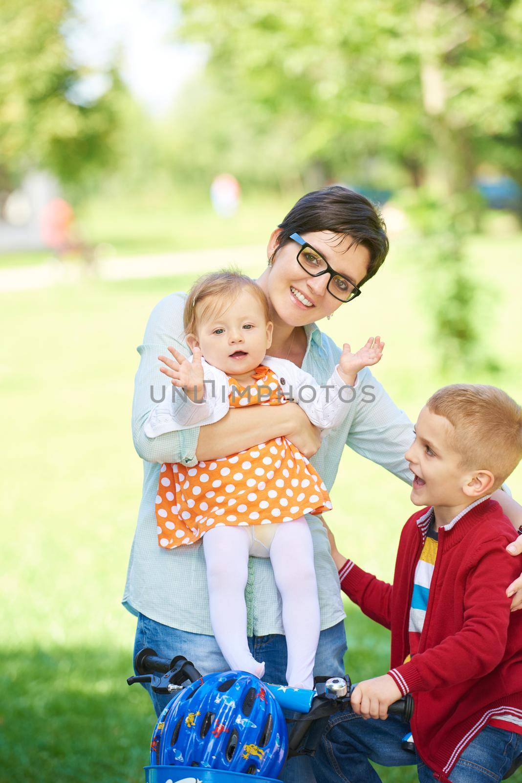 happy young family in park by dotshock