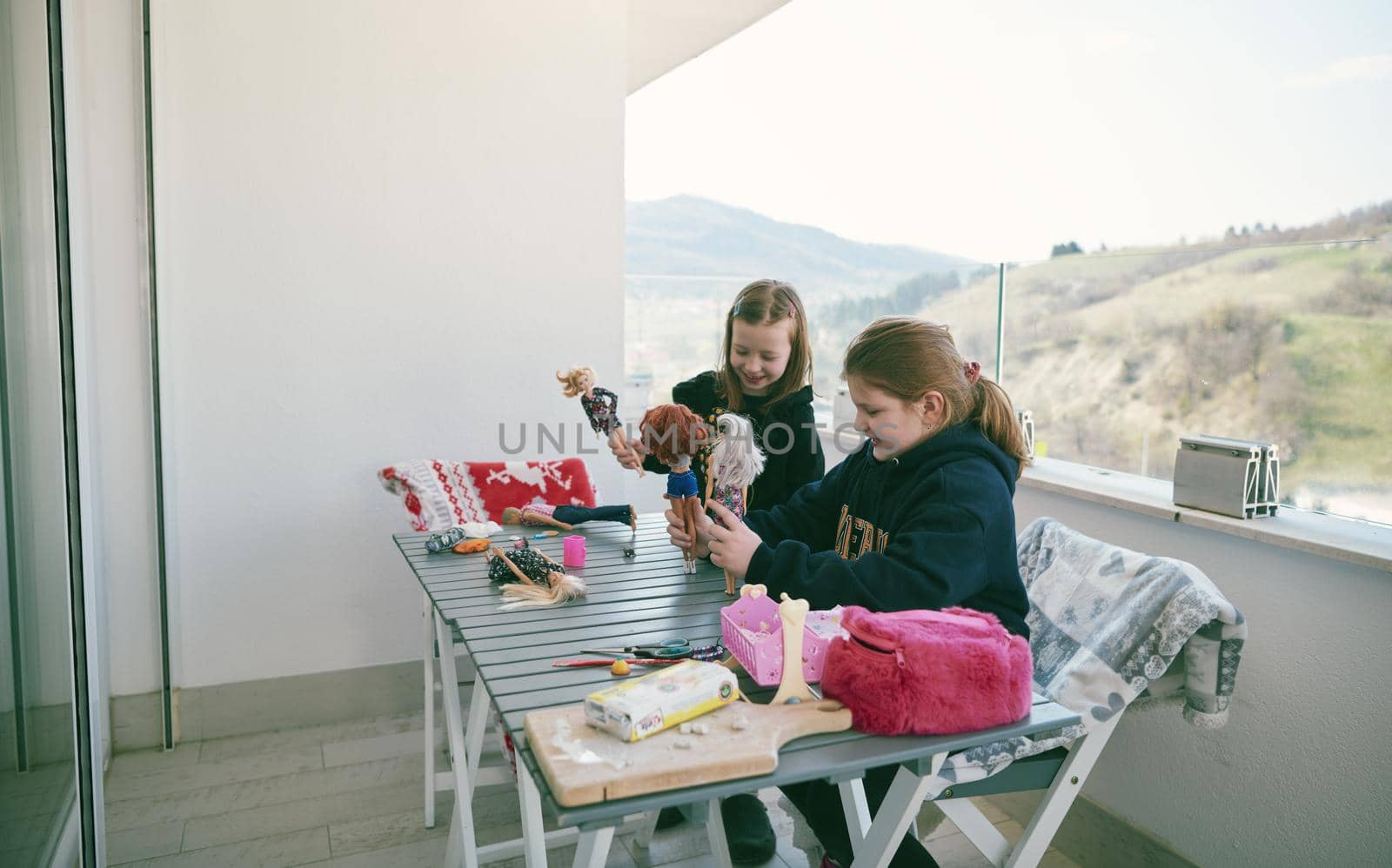 little girls playing with dolls by dotshock