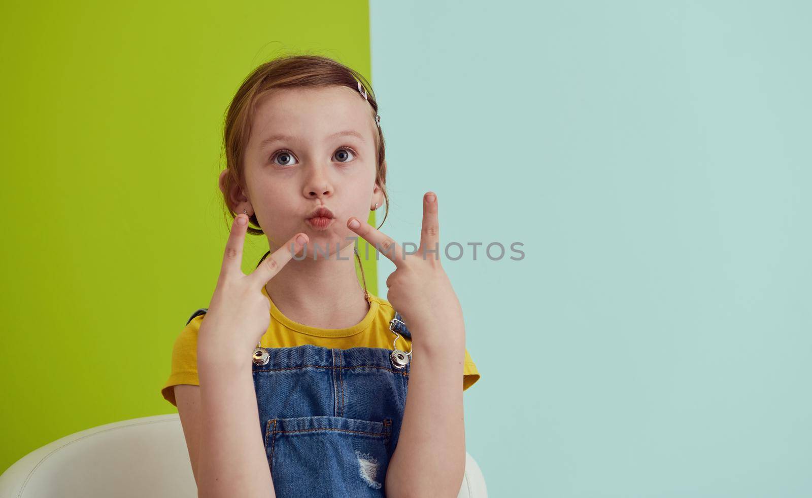 cute children portrait. Little girl smiling at home making funny face and acting