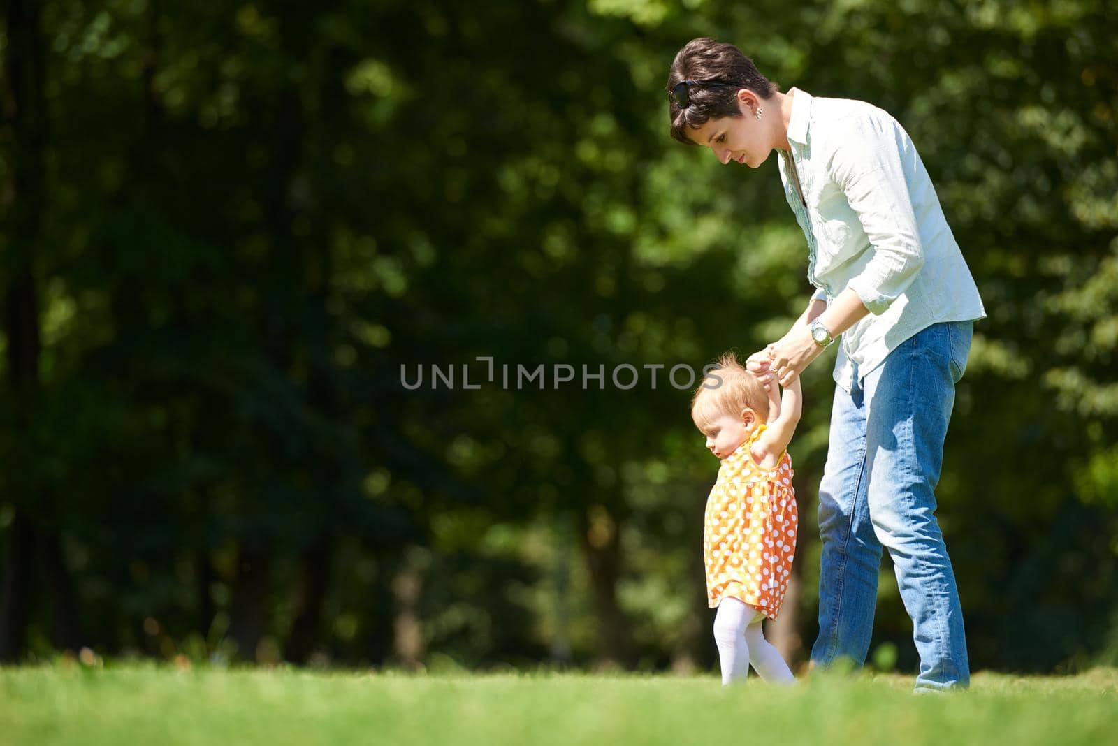 mother and baby in park by dotshock