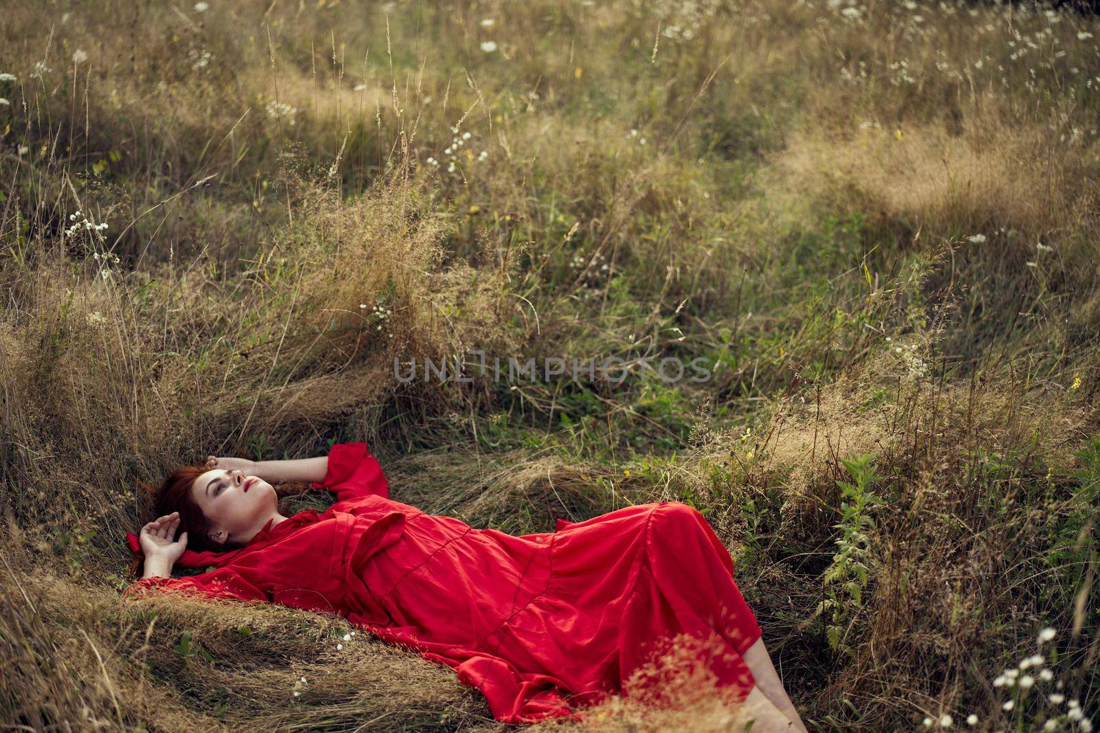 woman in a black dress lies in a field nature fashion summer. High quality photo