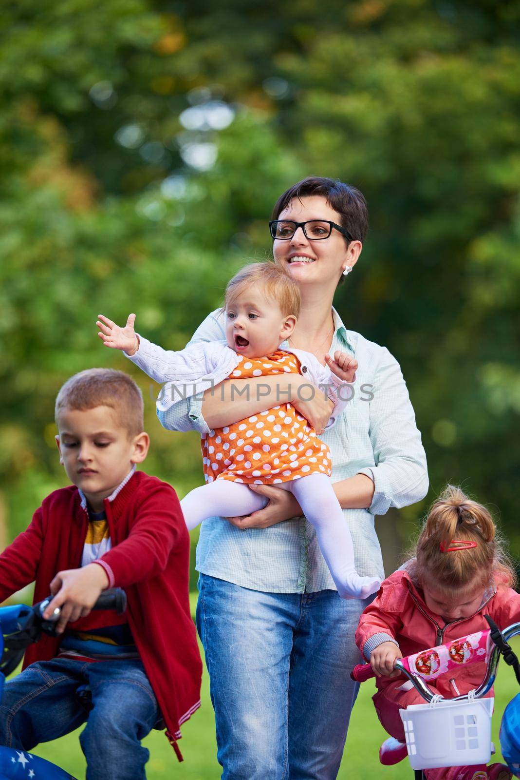 modern mother portrait  with kids in park by dotshock