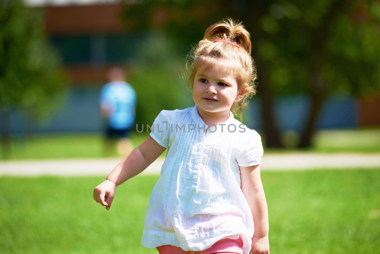 little girl have fun in park by dotshock