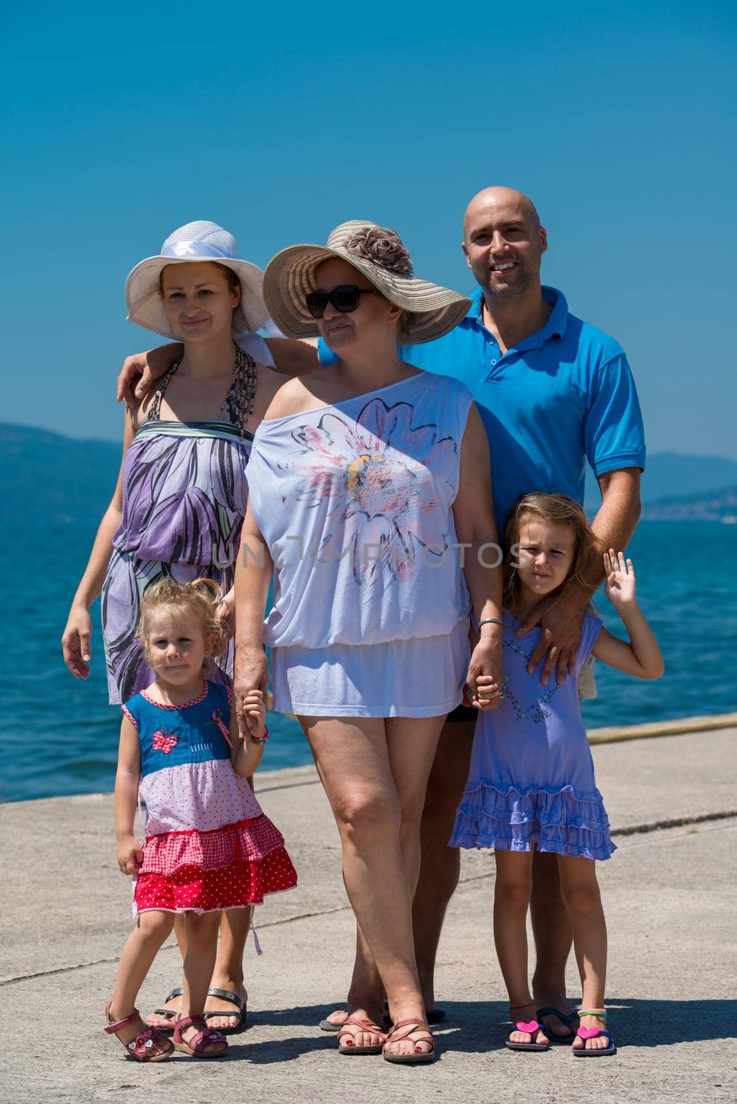 Portrait of happy multi generation family holding their hands while standing on the beach coast during Summer vacation Healthy family lifestyle concept