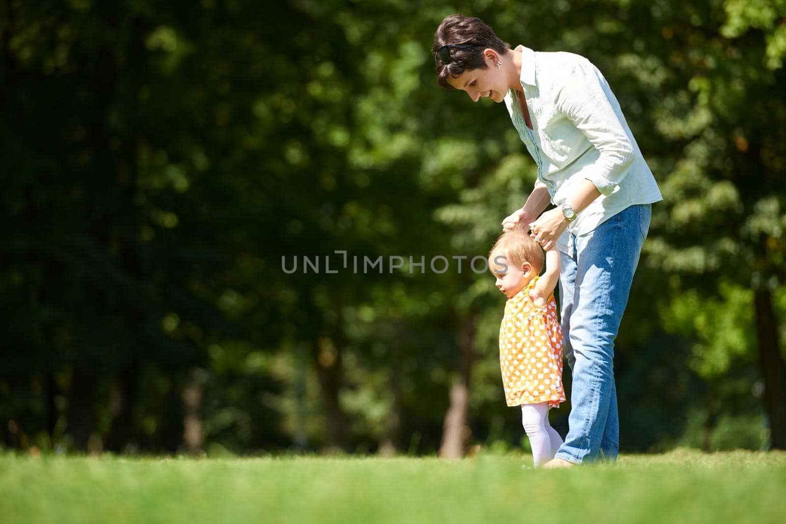 mother and baby in park by dotshock