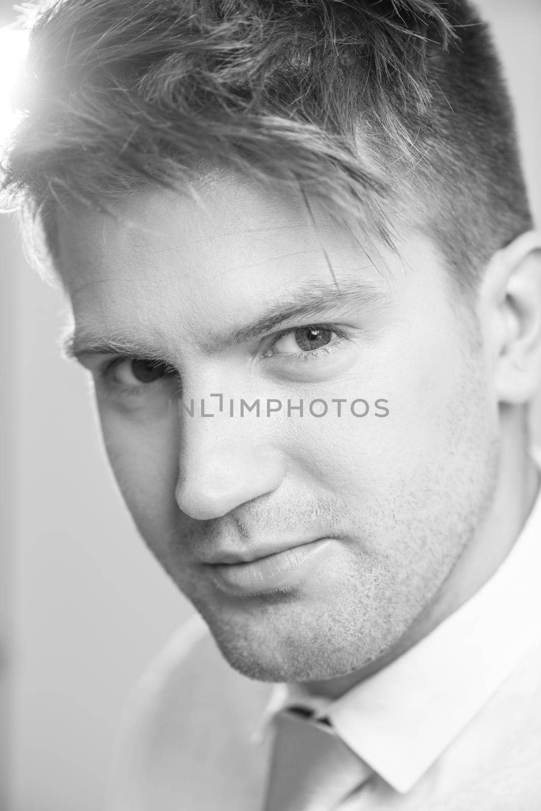 Portrait of a young handsome man in a representative strict clothing smiling isolated on white background