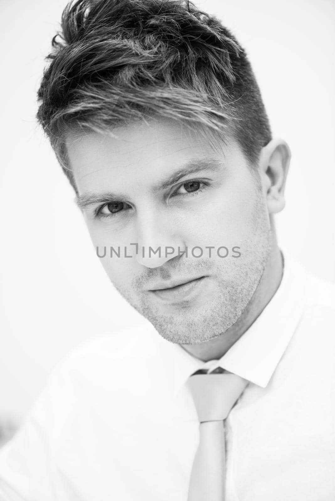 Portrait of a young handsome man in a representative strict clothing smiling isolated on white background