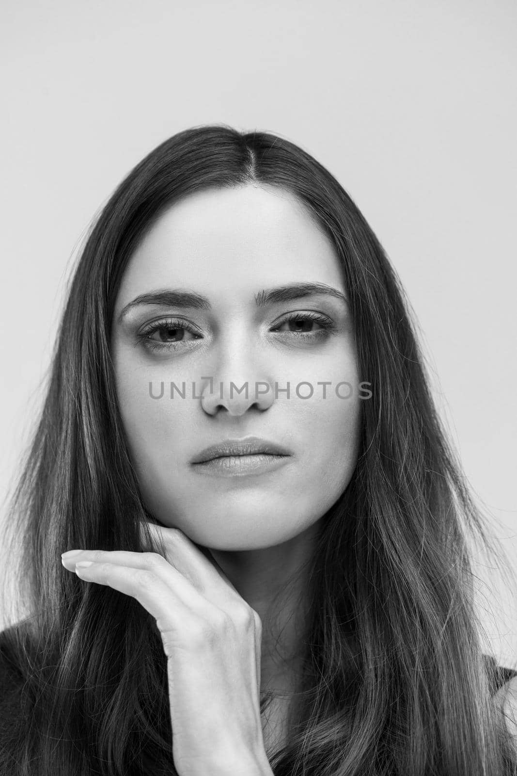 beautiful young brunette woman in a gray dress posing and expresses different emotions. close-up portret