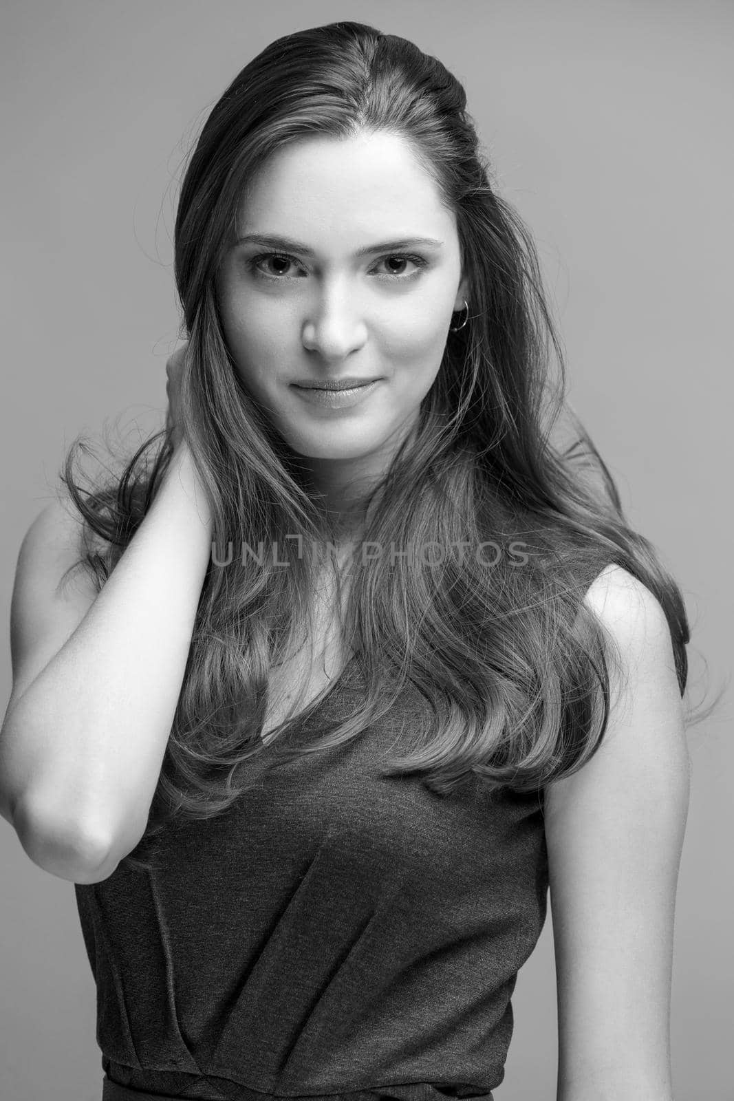 beautiful young brunette woman in a gray dress posing and expresses different emotions. close-up portret