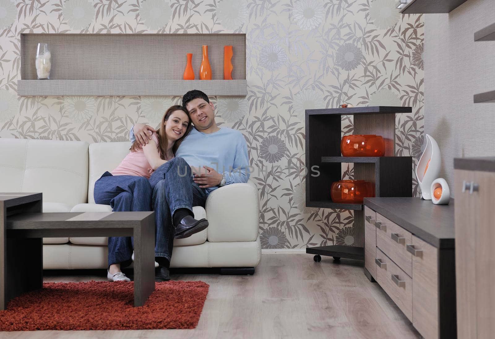 happy young couple relax at home in modern and bright living room 