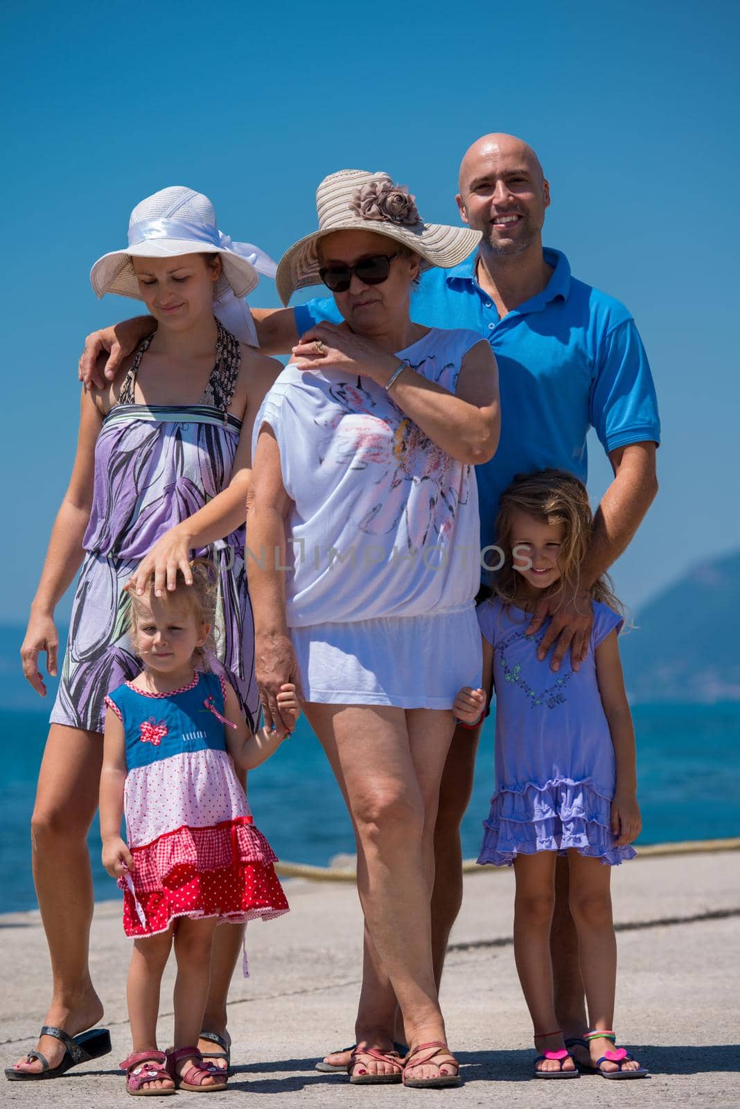 Portrait of happy multi generation family holding their hands while standing on the beach coast during Summer vacation Healthy family lifestyle concept