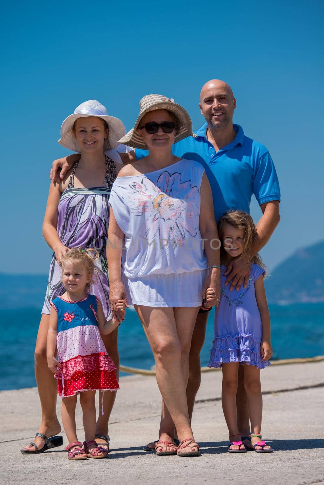 Portrait of happy multi generation family holding their hands while standing on the beach coast during Summer vacation Healthy family lifestyle concept