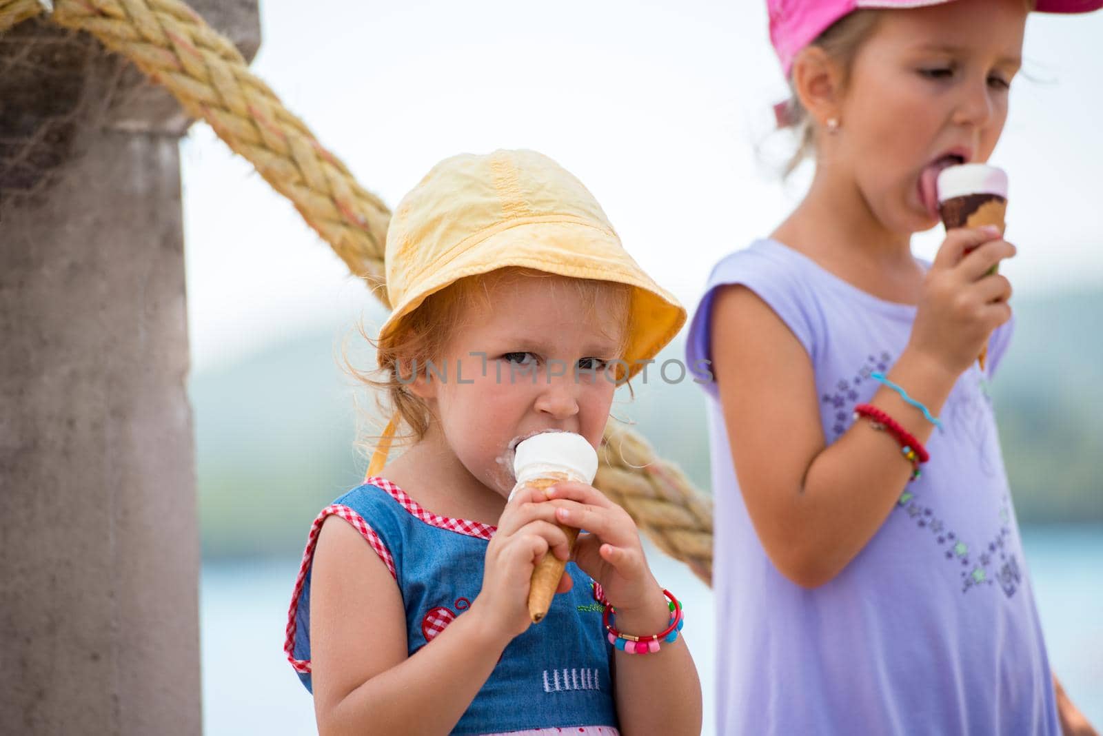 little girls eating ice cream by the sea by dotshock