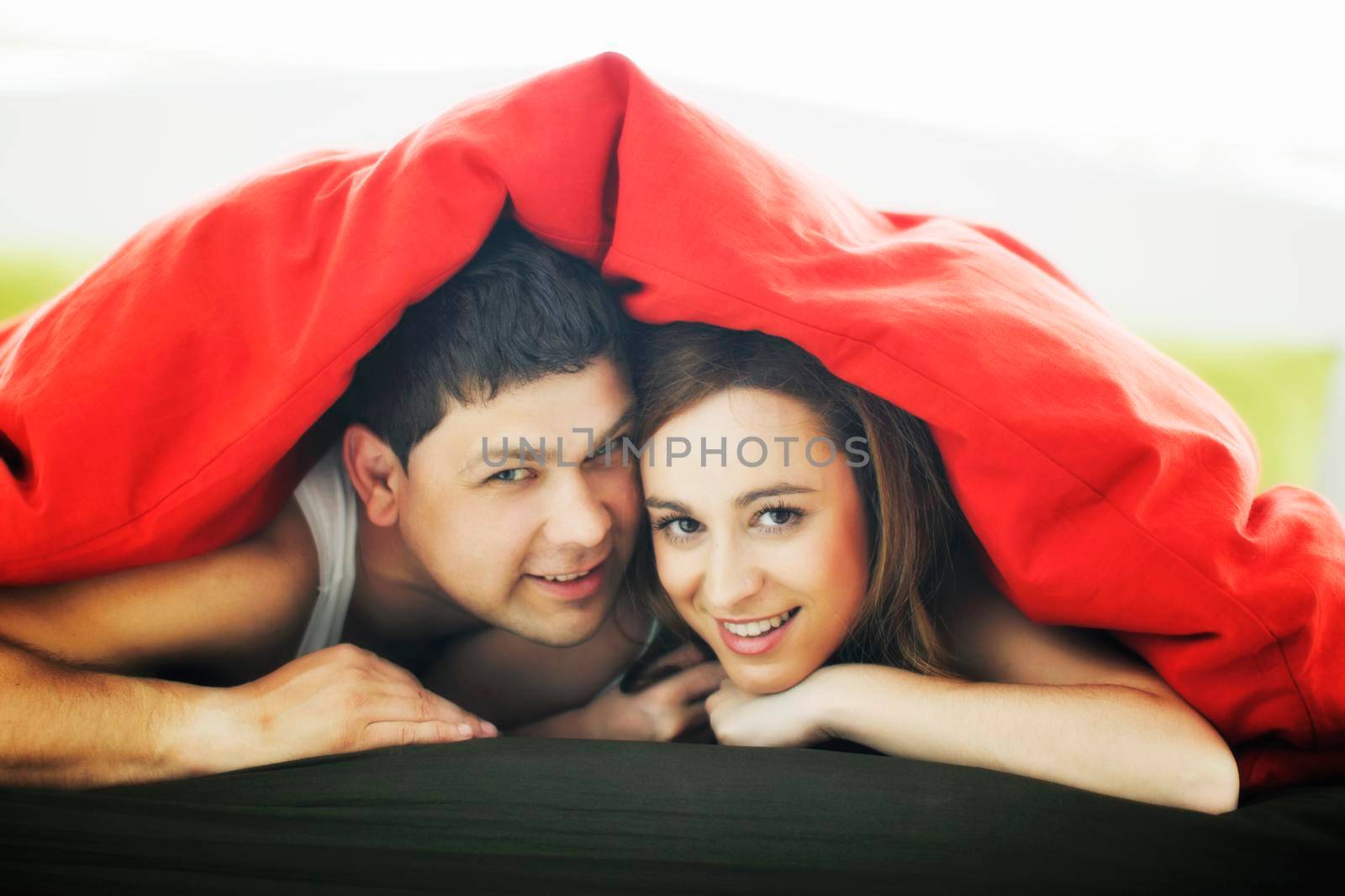 happy young couple in bed at morning