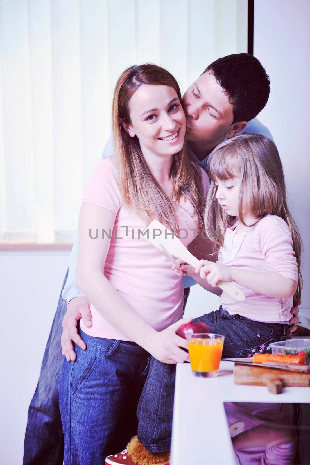 happy young family have lunch time with fresh fruits and vegetable food in bright kitchen 