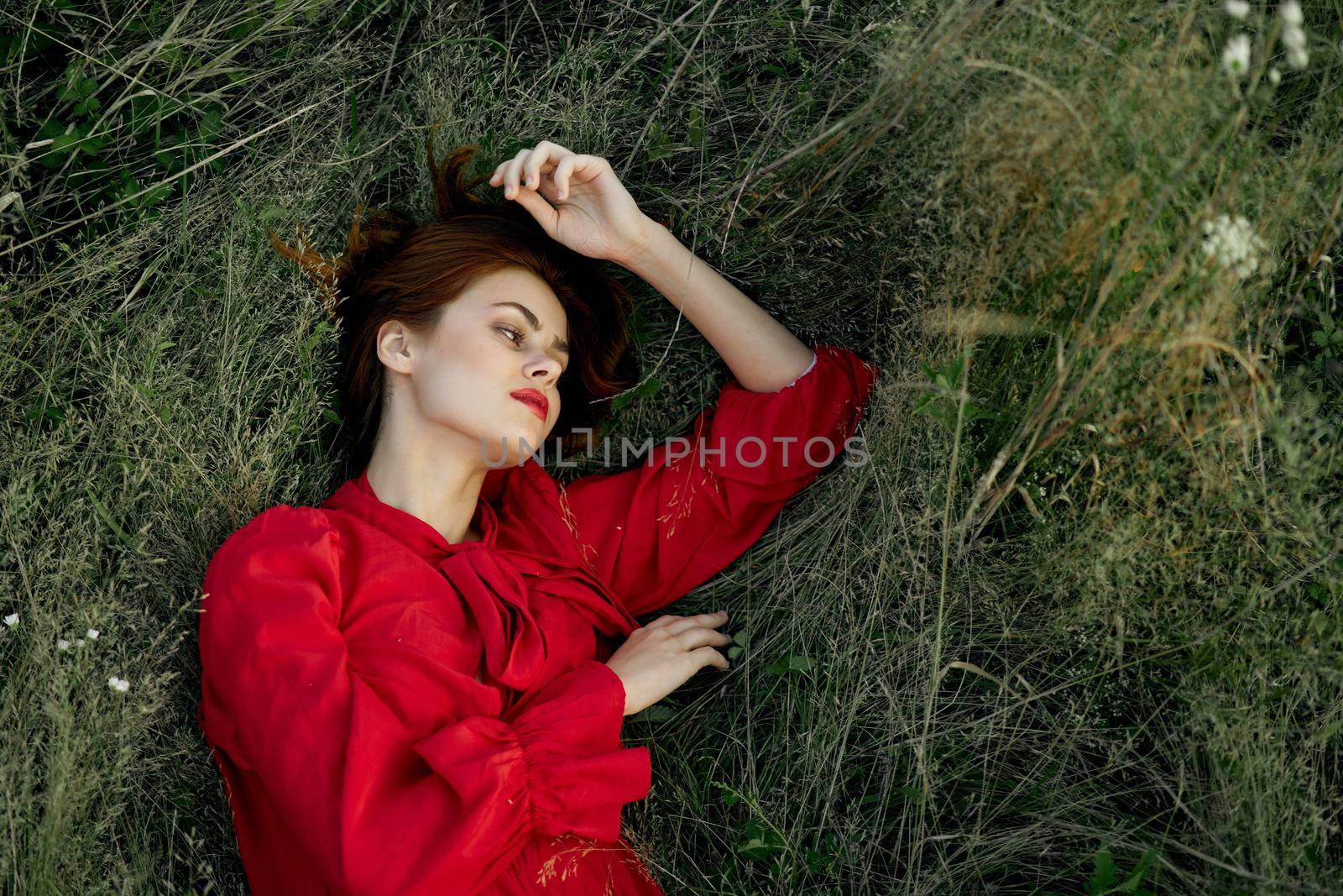 woman in red dress lies on the grass nature freedom summer by Vichizh