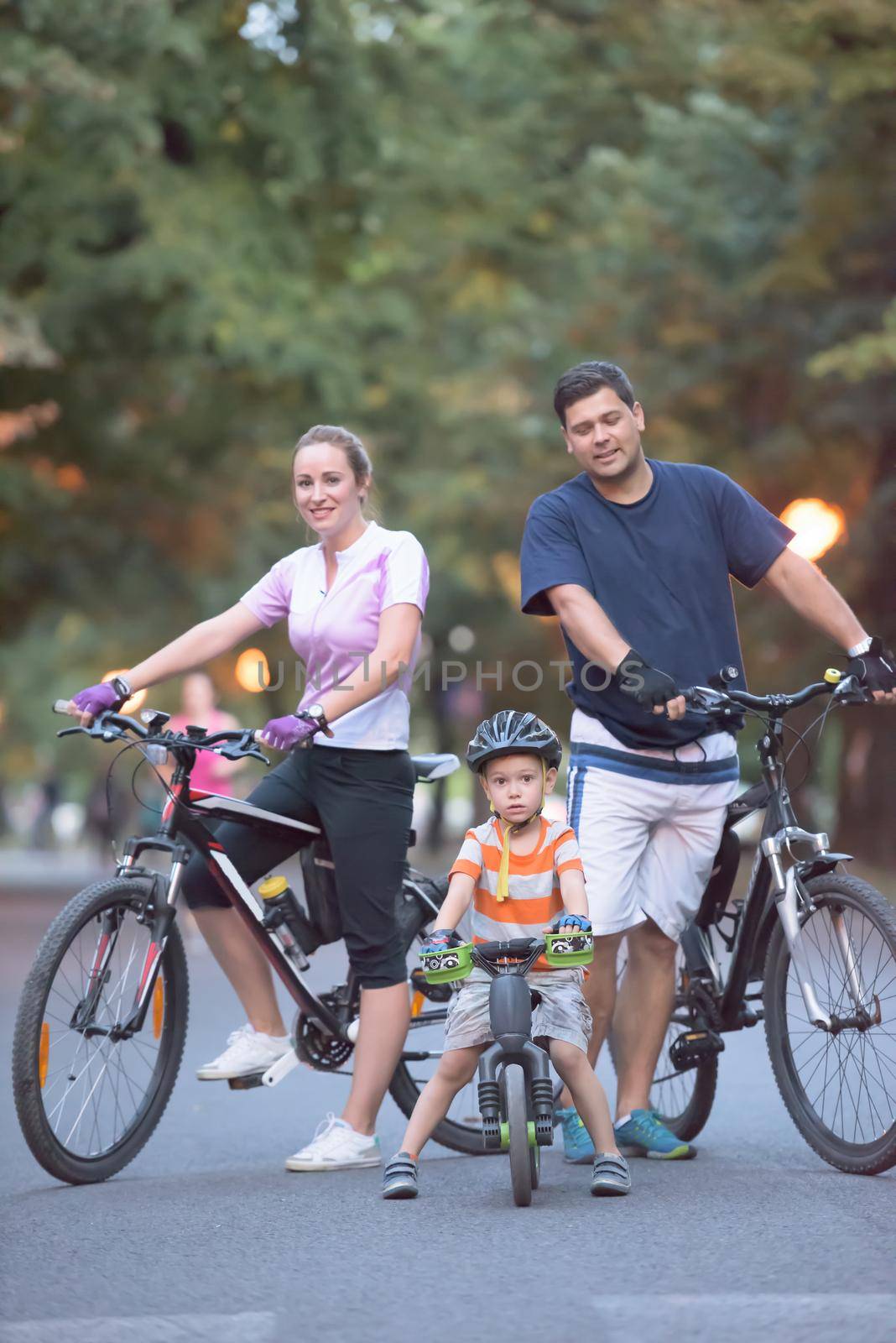 young family with bicycles by dotshock